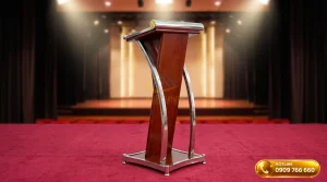 Bục phát biểu inox phối gỗ thân màu nâu đỏ bọc khung inox uốn cong sang trọng tại phòng hội nghị